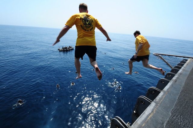 People jumping off a ship