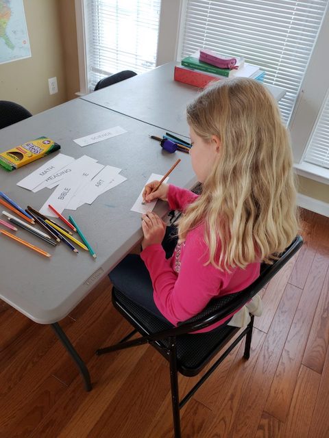 Homeschool Kid coloring her routine cards