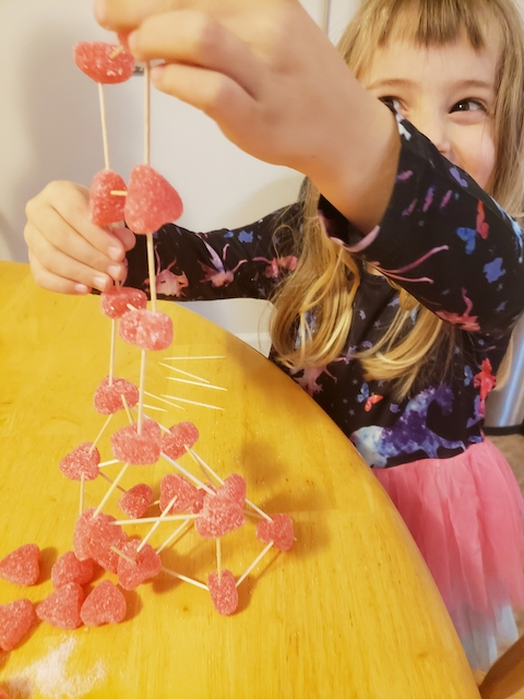 Preschooler working on Valentine's Day STEM Activity