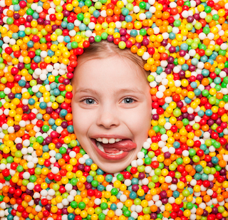 homeschool kid covered in candy from bribing or rewards